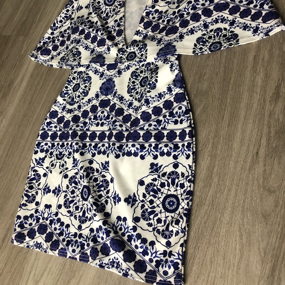 White cape dress with navy pattern